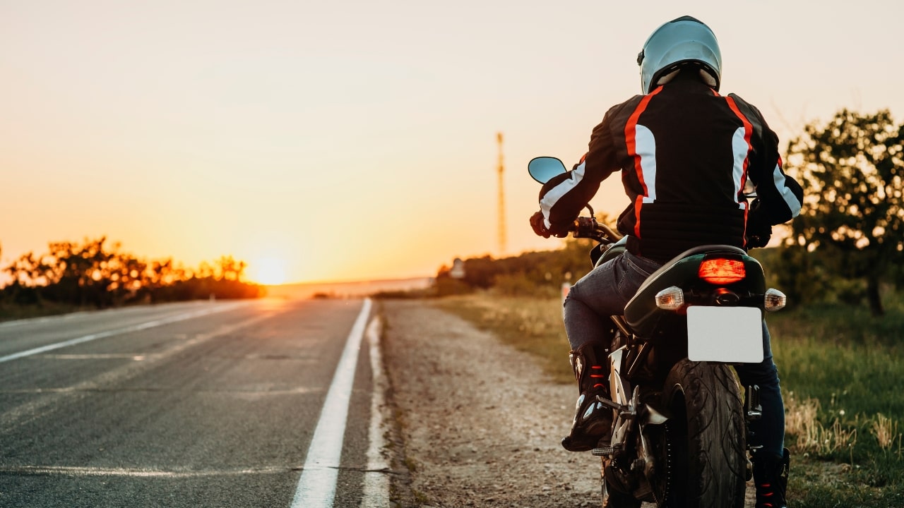 Man On Motorbike Riding On Roadside